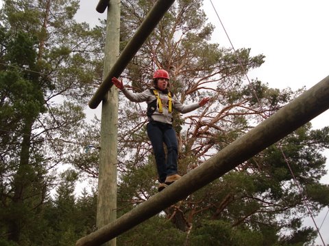 Girl on high beam obstacle course